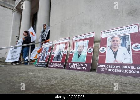 London, Großbritannien. 28. September 2025. Fotos von medizinischem Personal, das von Israel inhaftiert oder getötet wurde, werden als Gegner des israelischen Krieges gegen Gaza gezeigt, die vor dem Verteidigungsministerium ein Ende der "Spionageflüge" vom Luftwaffenstützpunkt Akrotiri der Royal Air Force (RAF) in Zypern fordern. Die Überwachungsflüge über Gaza sollen Israel nachrichtendienstliche Informationen teilen und, so Kritiker, ernsthafte rechtliche und ethische Fragen aufwerfen. Der Protest, der von Codepink UK und Verbündeten organisiert wurde, wurde live von Rednern einer ähnlichen Veranstaltung in Zypern gehört. Quelle: Ron Fassbender/Alamy Live News Stockfoto