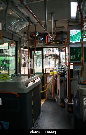 TOKIO, JAPAN - 28. OKTOBER 2024 - Vertikales Bild des Innenraums eines öffentlichen Busses ohne Personen, parkt in der Nähe des Bahnhofs Kichijoji in Tokio. Stockfoto