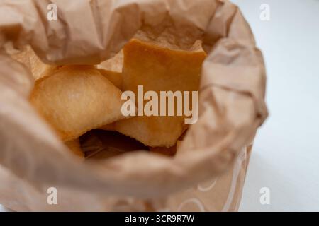 Warme, einladende Lichter strömen in einen privaten Veranstaltungsort, in dem die Gäste einen wunderschönen Mittagstisch genießen können Stockfoto