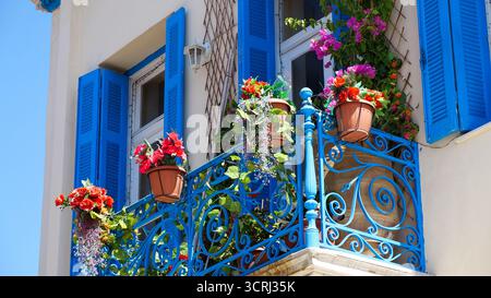 Blauer Balkon im mediterranen Stil mit Blumen in Athen, Griechenland Stockfoto
