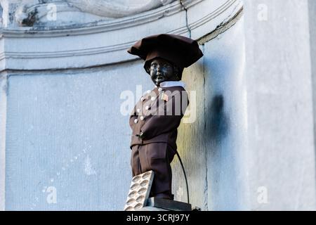 BRÜSSEL, BELGIEN - 1. OKTOBER 2025 Im Zentrum von Brüssel wurde die berühmte Manneken Pis Statue im Gourmet-Geist mit einem besonderen Schokoladenoutfit gekleidet! Schokoladenhersteller-Kostüm, das 2019 anlässlich der Einweihung der Chocostory Brussels, des Schokoladenmuseums, der Rue de l'Etuve angeboten wird, nur wenige Schritte vom Manneken-Pis-Brunnen entfernt. Kredit: Morfo SAVVA | Alamy Live News. Stockfoto