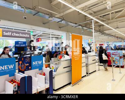 Salford, Großbritannien - 25. September 2025: Shopper Schlange an der Selbstkasse in einem großen englischen Supermarkt, geschäftig und hell. Stockfoto