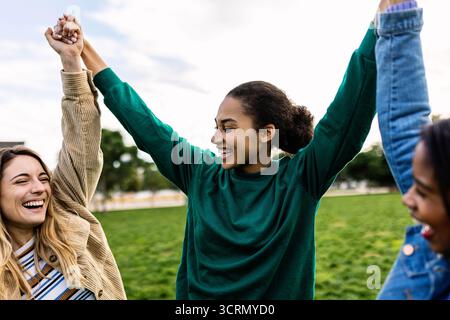Verschiedene Freundinnen feiern die Einheit und halten die Hände Stockfoto