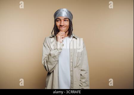 Junge Person mit nachdenklichem Ausdruck, die eine durag trägt. Stockfoto