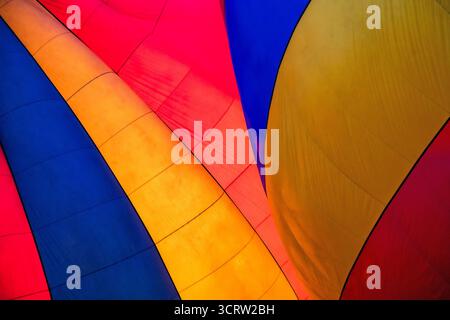 Aufgeblasenes Baldachin mit einem Heißluftballon-Detail. Radialer abstrakter Hintergrund in den Primärfarben Rot, Gelb und Blau. Stockfoto