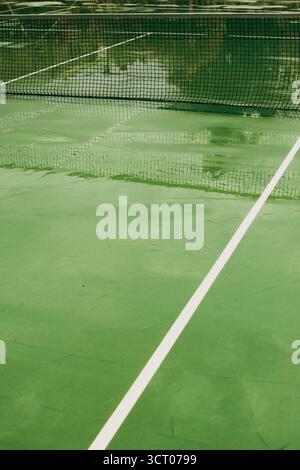 Ein ruhiger Tennisplatz in Heraklion, Griechenland, ohne Spieler oder Ablenkungen. Die Szene betont klare Linien, offene Räume und die Geometrie von Stockfoto