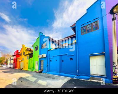 Farbenfrohe Reihe von lebhaften, bemalten Gebäuden an einem sonnigen Tag, die städtische Architektur in Blau-, Grün-, Gelb- und Rottönen in ipoh, malaysia, zeigen Stockfoto