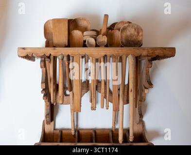 Ein Holzregal mit vielen Holzlöffeln und Spateln darauf. Die Löffel und Spatel haben alle verschiedene Größen und Formen. Stadt Puebla, Mexiko, Kunsthandwerk Stockfoto