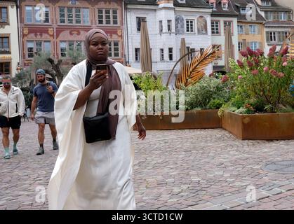 Frau, die ihr Handy benutzt, während sie in Mulhouse, Frankreich, läuft. Stockfoto