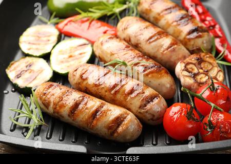Pfanne mit gegrillten Würstchen, Gemüse und Gewürzen, Nahaufnahme Stockfoto