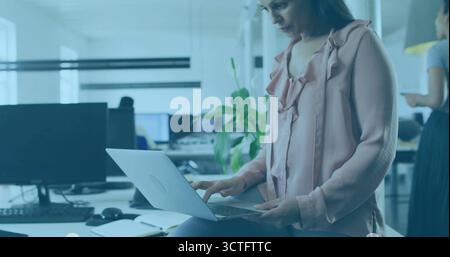 Sitzende Geschäftsfrau, die am Laptop am Schreibtisch im Großraumbüro schreibt, Smartphone-Notebook, Kopierraum Stockfoto