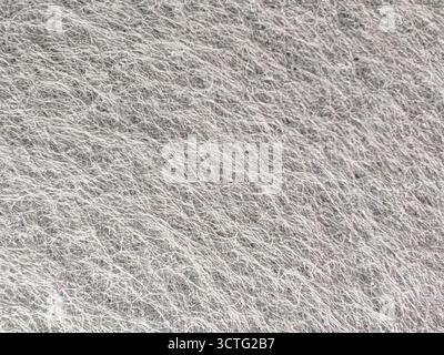 Detaillierte Nahaufnahme der Textil-Textur aus grauem Vliesstoff für Hintergrund und Design Stockfoto