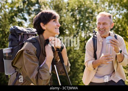 Seniorenpaar genießt gemeinsam die Natur und wandert mit Freude über wunderschöne Bergwege. Stockfoto