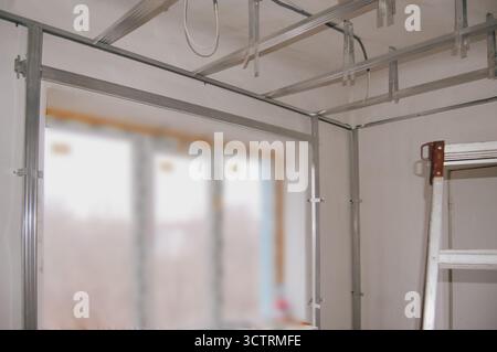 Drywall frame installation around window opening and on ceiling for renovation work. Stockfoto