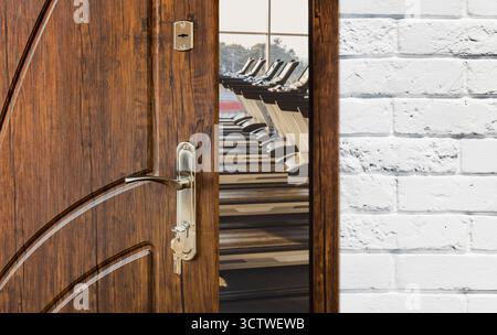 Zugang zum Fitnessstudio im Fitnessclub, offene Tür mit Laufbändern Stockfoto