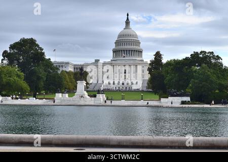 Ein bewölkter Tagesblick auf das US Capitol Building über dem Capitol Reflecting Pool. Das Ulysses S. Grant Memorial ist im Vordergrund des Kapitols zu sehen. Stockfoto