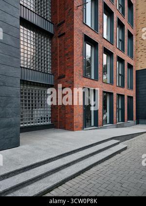 Moderne Ziegelfassade mit Glasblöcken. Veranda eines Wohngebäudes in der Altstadt. Stockfoto