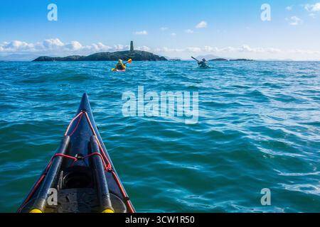Kajakfahren im Rhoscolyn Beacon vor der Küste von Anglesey / Ynys Mon in Nordwales, Großbritannien Stockfoto