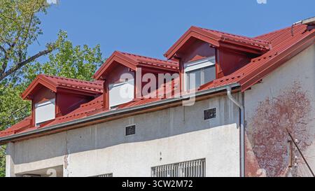 Dormer Fenster in neuem rotem Wellblechdach Stockfoto