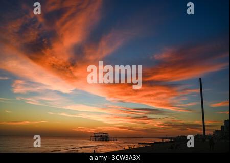 Brighton UK 9. Oktober 2025 - Besucher genießen einen wunderschönen Sonnenuntergang über Brighton Beach und dem West Pier nach einem weiteren warmen Tag entlang der Südküste: Credit Simon Dack / Alamy Live News Stockfoto