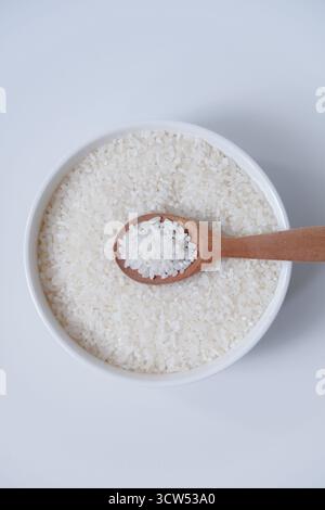 Eine Schüssel Reiskörner isoliert auf weißem Hintergrund Stockfoto