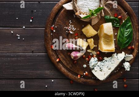 Käsedelikatessen auf rustikalem Holz, blauem roquefort, Brie und Parmesan Stockfoto