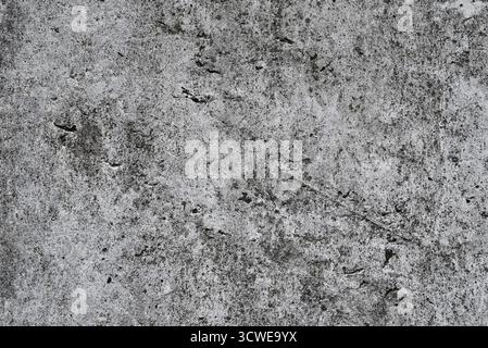 Raue graue Betonoberfläche mit Rissen und Flecken, Textur einer alten Wand. Stockfoto