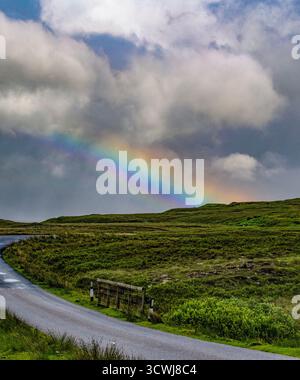 Schottland: rainbow nach einem Regenguss auf der Landstraße, die zum Quiraing führt, einzigartige Landform auf der Trotternish-Halbinsel der Isle of Skye Stockfoto