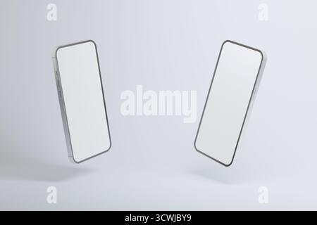 Zwei moderne Smartphones mit leeren weißen Bildschirmen, die vor hellem Hintergrund schweben, minimalistisches Mockup-Konzept für mobile Apps, Technologie, Digital Stockfoto