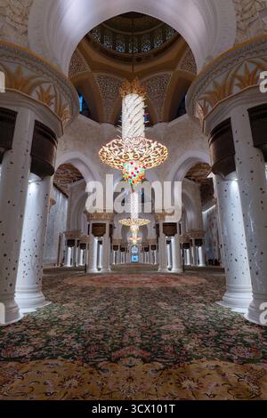 Abu Dhabi, VAE - 5. Februar 2023 .: Kronleuchter und der größte Teppich im Gebetssaal der Scheich-Zayed-Moschee, der größten Moschee in den VAE; Stockfoto