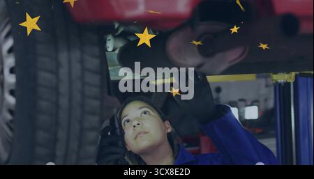 Inspektion Mechaniker in Overalls mit Handschuhen, Überprüfung der Autoabgase auf dem Aufzug in der Garage mit gelben Sternen Stockfoto