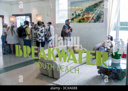 Miami Beach Florida,South Beach,Ocean Drive,Breakwater Hotel Lobby Inneneinrichtung,Gäste, die an der Rezeption einchecken,Reflexion auf Glastür Logo,Peop Stockfoto