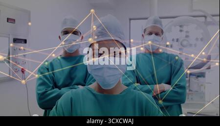 Stehende Chirurgin mit grünem Peeling, Kappe und Maske im OP, mit Datenüberlagerung Stockfoto