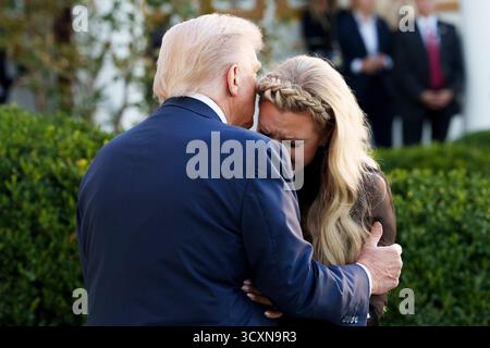 Präsident Donald J. Trump umarmt Erika Kirk in einem emotionalen Moment während der Zeremonie zu Ehren ihres verstorbenen Ehemanns Charlie Kirk mit der Presidential Medal of Freedom im Rose Garden des Weißen Hauses am 14. Oktober 2025. Bild mit freundlicher Genehmigung des Weißen Hauses. Stockfoto