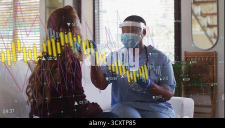 Messschwester in Peelings mit Stirnthermometer an Patientenbraue im Wohnzimmer, Datendiagramme Stockfoto
