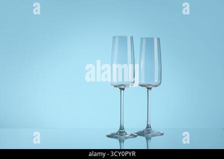 Leere Sektgläser auf blauem Hintergrund Stockfoto