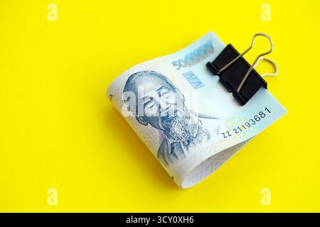 Vietnamesische Dong-Geldscheine in großer Höhe in der Nähe auf Gelb. Finanz- und Bankkonzept Stockfoto