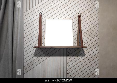 Quadratischer Druck auf einem Holzregal in einem modernen Wohnzimmer als Modell für Print on Demand für eine E-Commerce-Website oder soziale Medien. Stockfoto