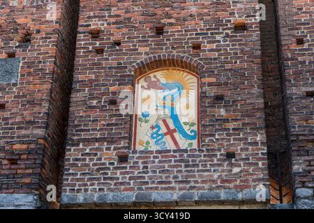 Italien, Mailand - 17. Juli 2025: Wappen und Schild der Burg Sforza in Mailand. Antike italienische mittelalterliche Architektur. Altes Gebäude mit Mauerfassade und Festungsturm Stockfoto