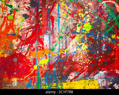 Abstrakt lebendiger Farben, die über die Leinwand gespritzt werden Stockfoto