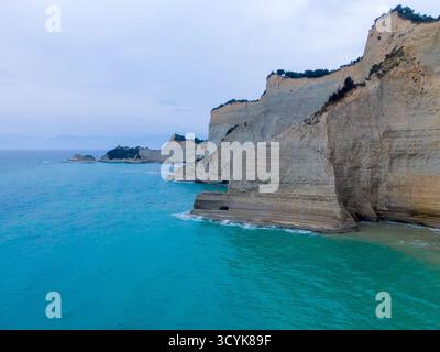Dramatische Kalksteinklippen von Kap Drastis, Korfu, Griechenland, mit türkisfarbenem Ionischen Meer und atemberaubenden Felsformationen, die eine atemberaubende Küstenlandschaft schaffen Stockfoto