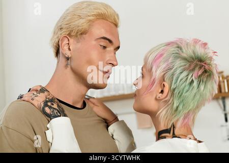 Ein junges Paar teilt einen intimen Blick, umgeben von einer warmen und einladenden Atmosphäre, die Freude ausstrahlt. Stockfoto