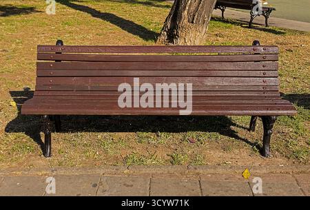 Leere Retro-Holzbank im öffentlichen Park in der Stadt Stockfoto