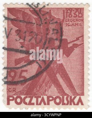 POLEN — 1. November 1930: 25 grossige rotbraune Briefmarke, die stilisierte Soldaten in der Offensive darstellt. 100. Jahrestag des Aufstands von 1830. Der Novemberaufstand, auch bekannt als Polnisch-Russischer Krieg oder Kadettenrevolution, war eine bewaffnete Rebellion im Kernland Polens gegen das Russische Reich. Der Aufstand begann 29.11.1830 in Warschau, als junge polnische Offiziere der Militärakademie der polnischen Armee unter der Führung von Leutnant Piotr Wysocki aufbegehrten. Große Teile der Bevölkerung Litauens, Weißrusslands und der rechtsrheinischen Ukraine schlossen sich bald dem Aufstand an Stockfoto