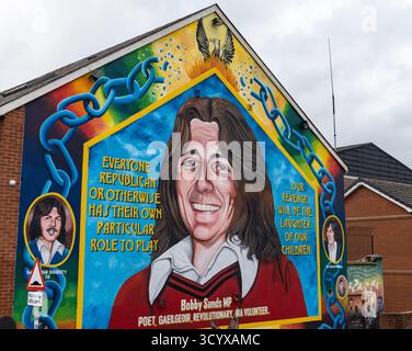 Farbenfrohes Wandgemälde an Bobby Sands an einer Giebelwand in der Falls Road Belfast mit seinem Porträt und politischen Zitaten mit hellen symbolischen Bildern Stockfoto