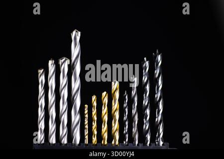 Satz mit 12 Bohrern für Holz, Metall und Mauerwerk isoliert auf schwarzem Hintergrund Stockfoto