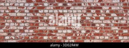 Wand aus roten weißen Ziegeln und Fugen aus grauem Mörtel Stockfoto