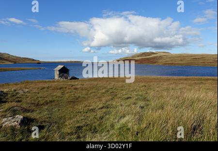 Das Old Remote Stone Boathouse am Devoke Water im Lake District National Park, Cumbria, England, Großbritannien. Stockfoto