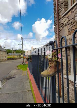Alter Stiefel, der als Blumentopf am Zaun im Dorf Dingle Peninsula, County Kerry, Irland verwendet wurde Stockfoto