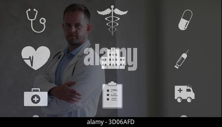 Stehender Arzt mittleren Alters, der Arme im Flur kreuzt, mit Stethoskop, schwebenden Ikonen, Kopierraum Stockfoto